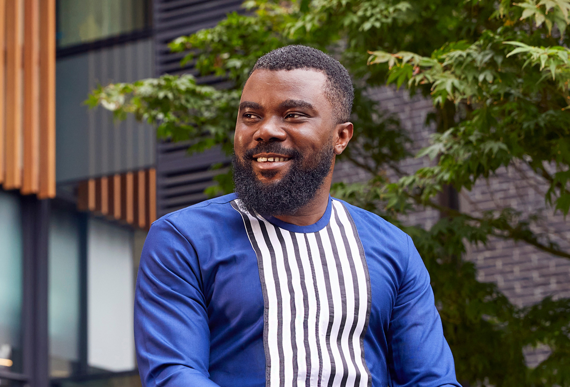 An Apple employee smiling and looking to the side.