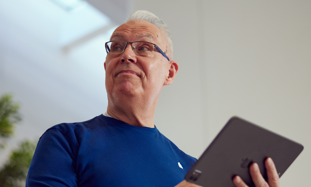 Close-up image of Tom holding an iPad.