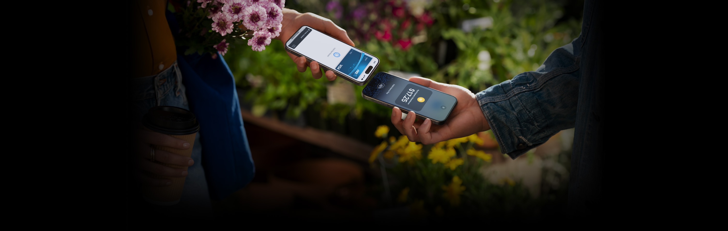 An image of two people holding their iPhone devices together completing a transaction.