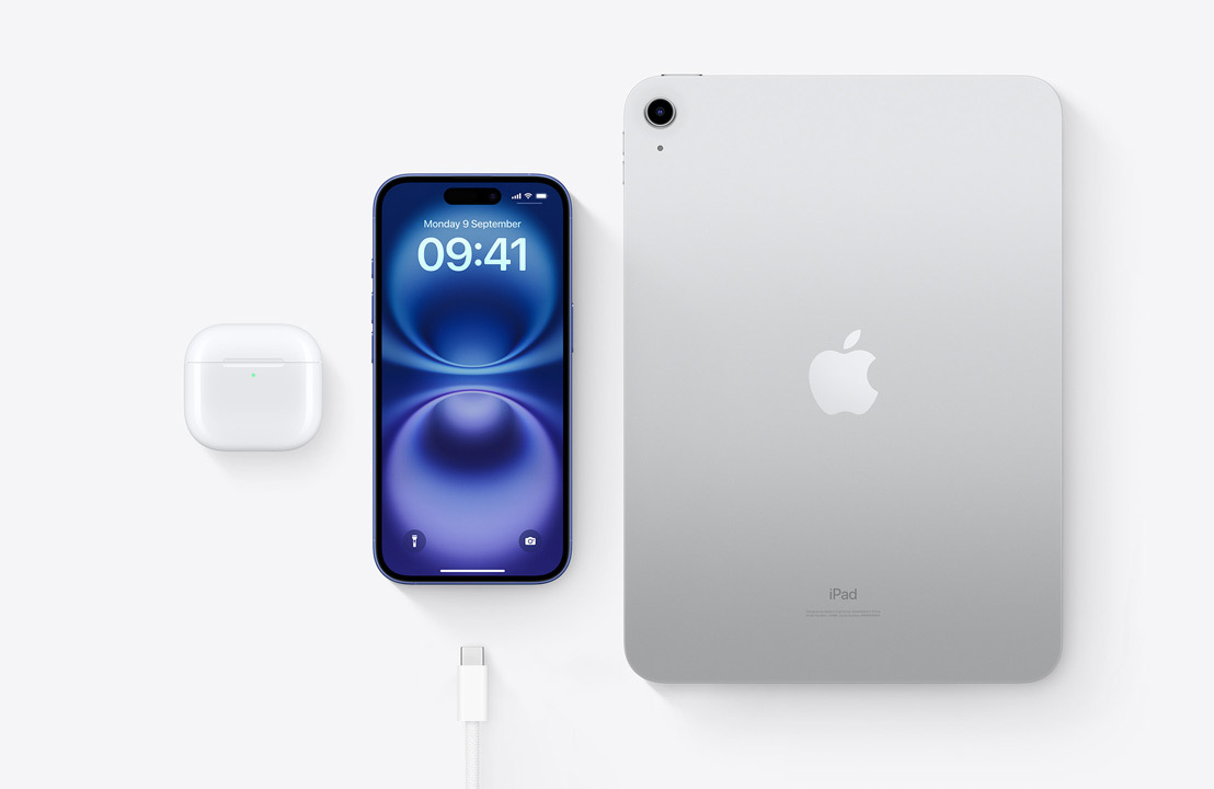 A birds-eye view of AirPods Pro, iPhone 15 and an iPad with a USB-C connector to demonstrate how all three devices can be charged using the same USB-C cable.