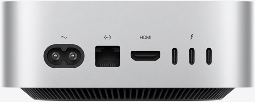 Pohľad zozadu na strieborný Mac mini, na ktorom sú vidieť zadné porty: jeden napájací port, jeden port Ethernet, jeden port HDMI a tri porty Thunderbolt.